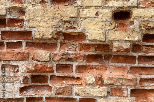 Antique dilapidated isolated brick wall for creating a design background