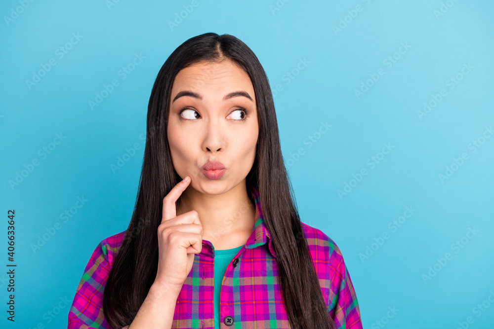Portrait of attractive lady finger on chin kiss lips look empty space wear violet plaid isolated on blue color background Portrait of attractive lady finger on chin kiss lips look empty space wear violet plaid isolated on blue color background