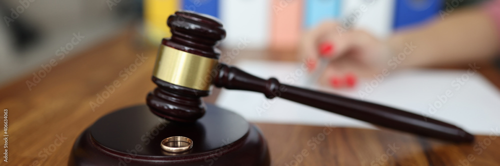 Wooden gavel for judge on stand is a wedding ring. Family divorce and division of property concept