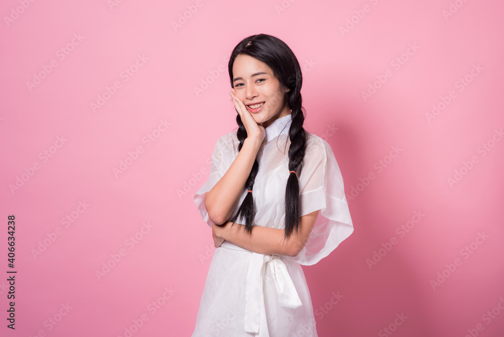 Happy cheerful young woman wearing her black hair rejoicing at positive news or birthday gift, looking at camera with joyful and charming smile. Asian girl portrait on pink background in studio Happy cheerful young woman wearing her black hair rejoicing at positive news or birthday gift, looking at camera with joyful and charming smile. Asian girl portrait on pink background in studio