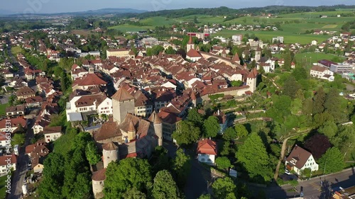 Aerial drone footage of the medieval Murten (Morat in French) old town in Canton Fribourg in Switzerland with a rotation and tilt down motion photo