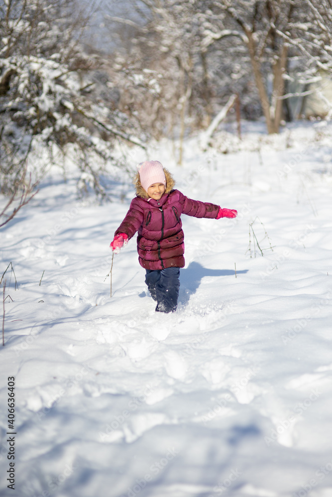 A child girl on a walk in a winter park A child girl on a walk in a winter park