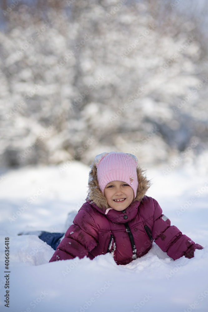 A child girl on a walk in a winter park A child girl on a walk in a winter park