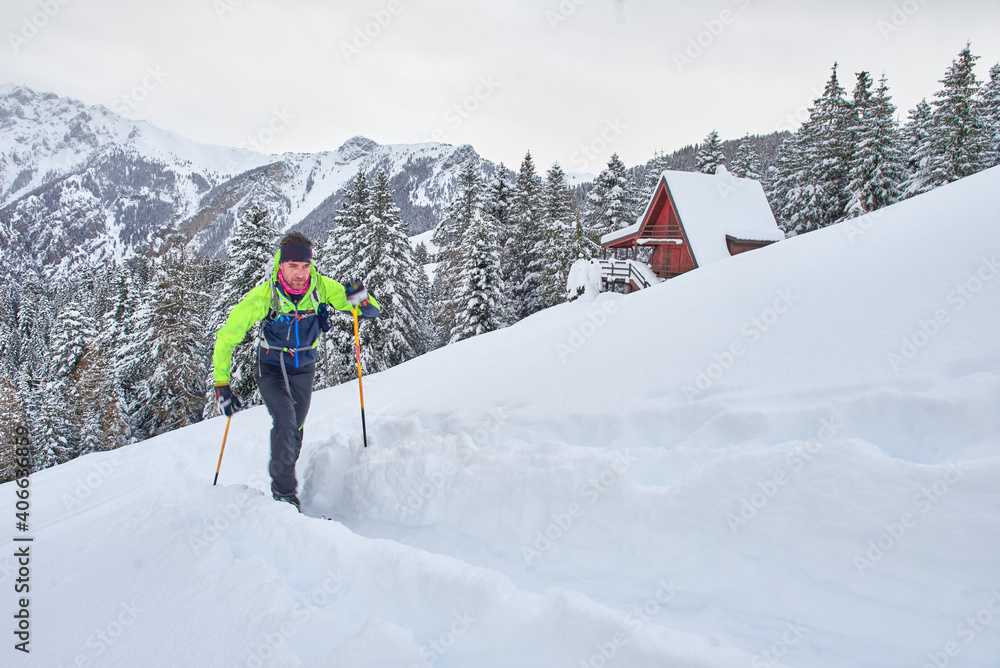 Young man in action on climbing touring skis