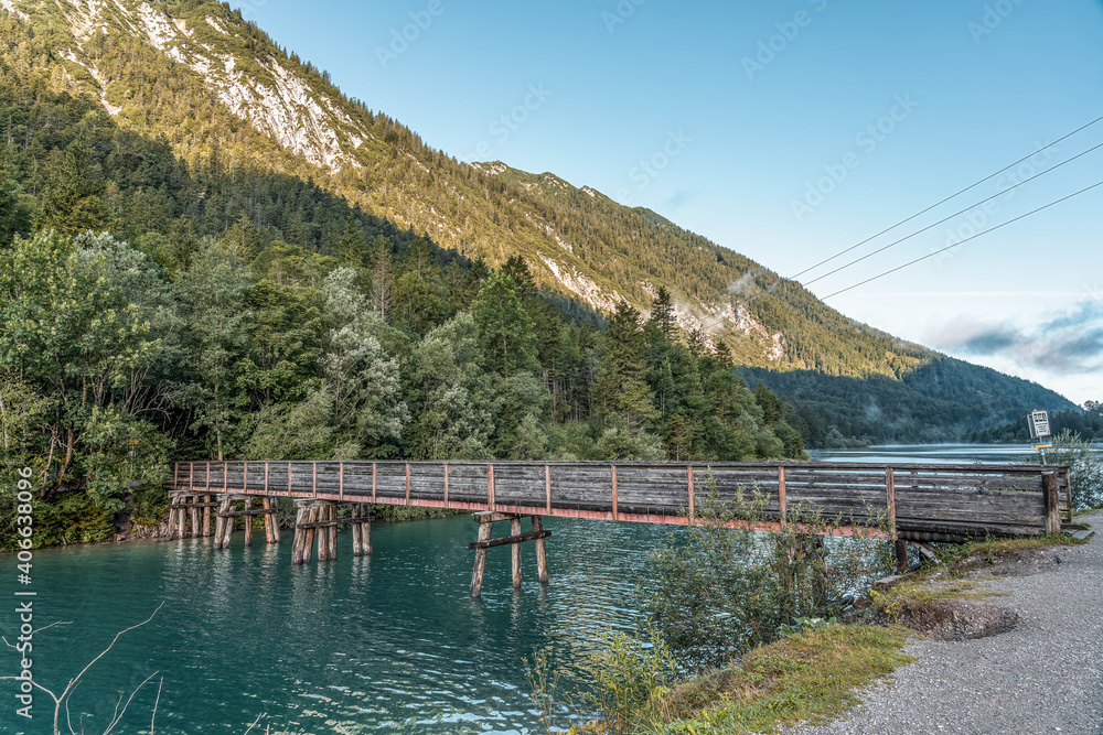 Wooden bridge over Plansee lake in Austria morning Wooden bridge over Plansee lake in Austria morning