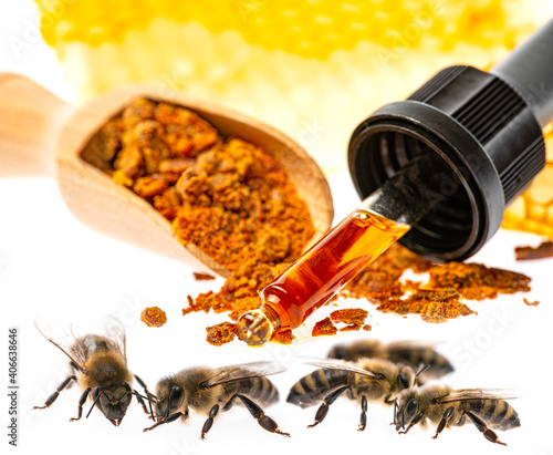 propolis tincture and a wooden spoon of propolis granules