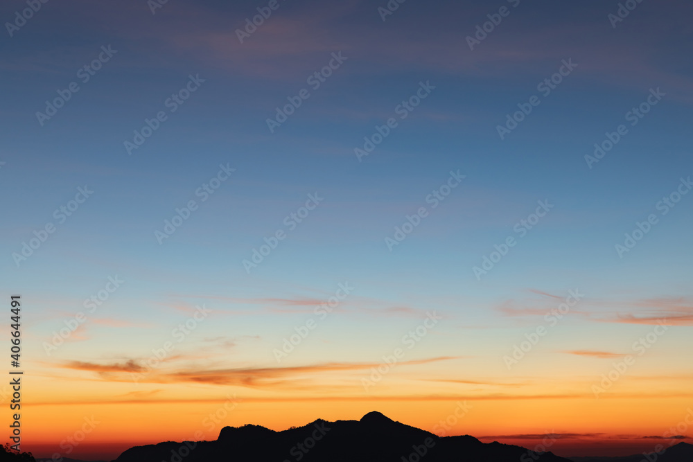 Heaven at early morning with copy space. Sunset, sunrise backdrop.Predawn clear sky with orange horizon and blue atmosphere. Smooth orange blue gradient of dawn sky.