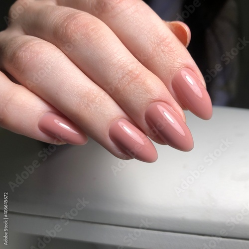 Stylish trendy female pink manicure.Hands of a woman with pink manicure on nails
