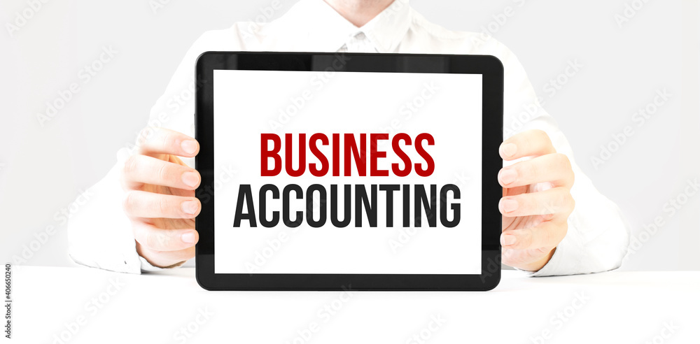 Text business accounting on tablet display in businessman hands on the white bakcground. Business concept