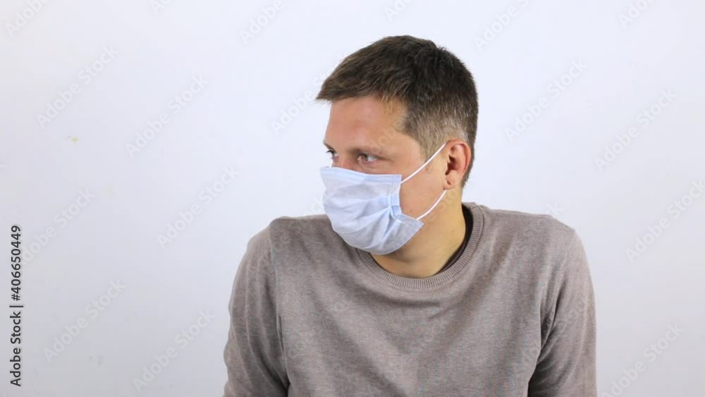 A young man is waiting for an appointment with a doctor. Man with viral infection wearing medical mask. A young man is waiting for an appointment with a doctor. Man with viral infection wearing medical mask.