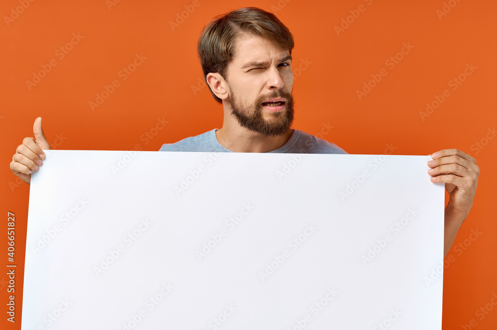 emotional guy holding a white sheet of paper in his hands Poster mockup advertising sign emotional guy holding a white sheet of paper in his hands Poster mockup advertising sign