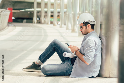 engineering man using mobile phone for work outdoors.