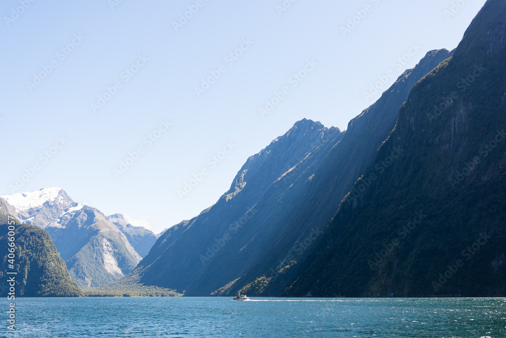Stunning light shines on cruise in Milford Sound fjord from cruise in New Zealand
