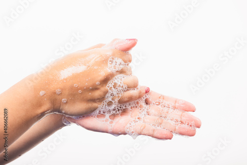 Closeup young Asian woman washing hands by soap for cleanliness and prevent germs coronavirus  studio shot isolated on white background  Healthcare medical COVID-19 virus concept