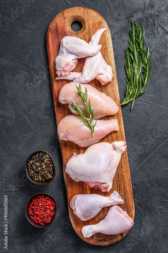 Fresh raw chicken meat and chicken parts. Black background. Top view photo