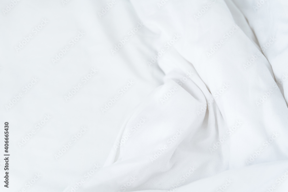 White crumpled sheet wavy mock up. Morning bed. Fabric textile texture. White minimalistic background. White crumpled sheet wavy mock up. Morning bed. Fabric textile texture. White minimalistic background.