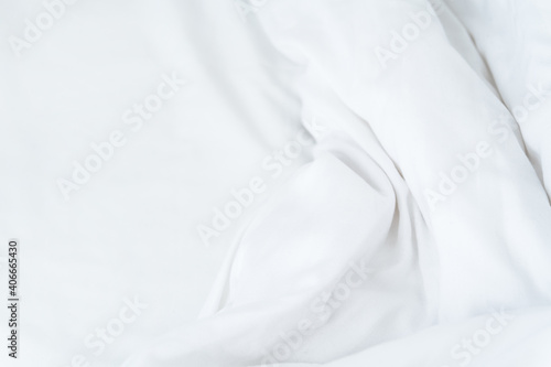 White crumpled sheet wavy mock up. Morning bed. Fabric textile texture. White minimalistic background.