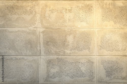 Background picture of bare cement wall with natural tones receiving sunlight