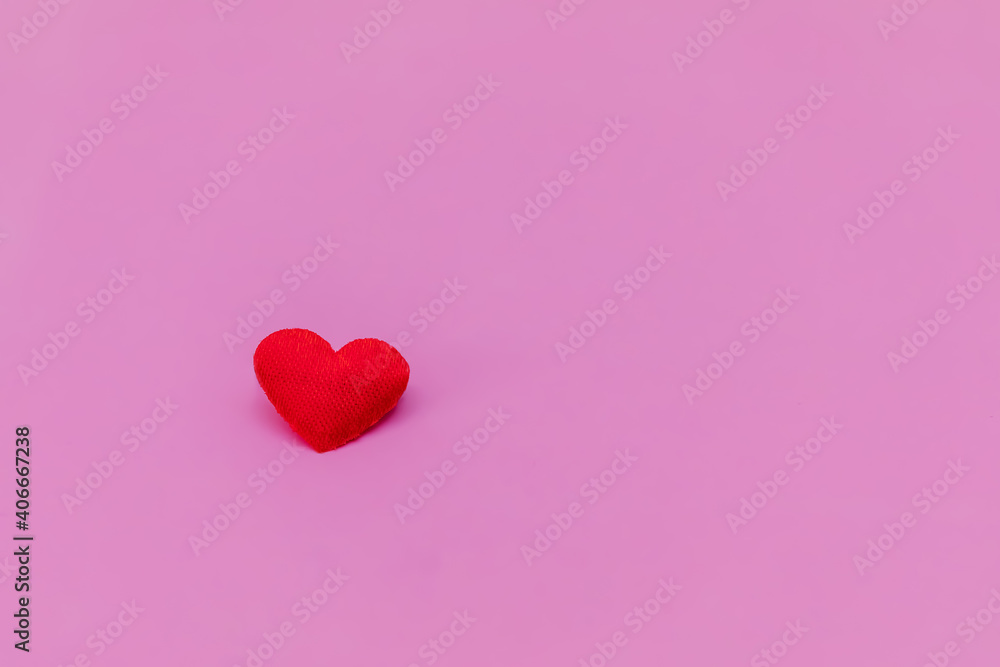 Red heart on a pink background. Composition for Valentine's Day. Flat lay, copy space, top view.