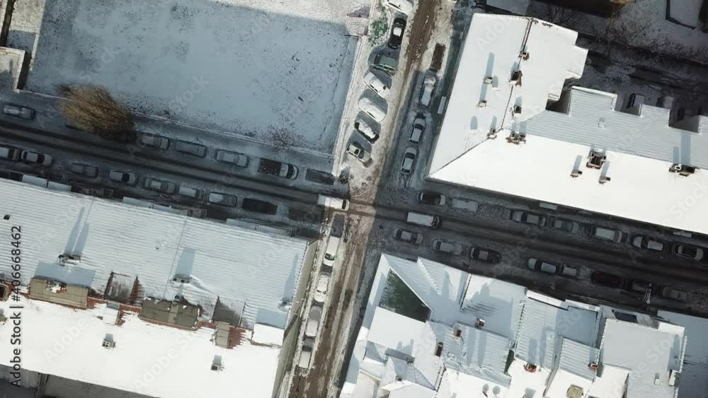 Aerial view of the empty and snowy city streets during the quarantine days. roads and buildings covered with snow Aerial view of the empty and snowy city streets during the quarantine days. roads and buildings covered with snow