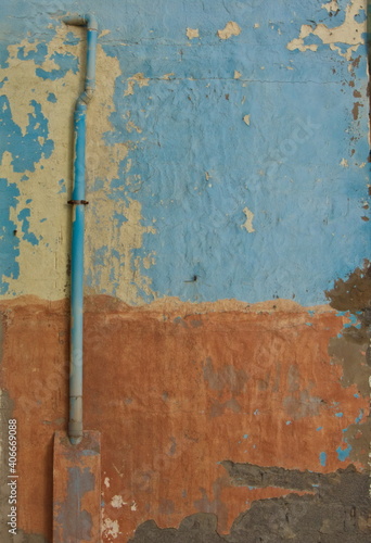 Aged multicolored wall with exterior pipe © P.canariensis