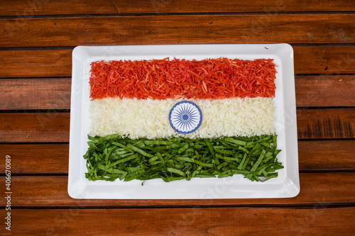 Indian republic day theme Indian flag depicted by food. Salad of fresh raw grated carrot, radish and spinach. photo