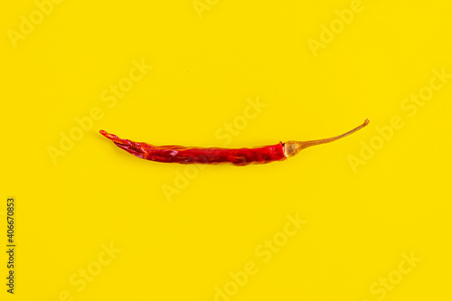 Dried red chili pepper on yellow background. Texture of isolated chili peppers