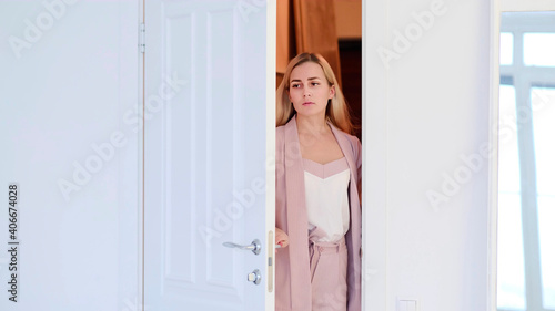 Woman opening door. tired woman enters a room or her apartment after a hard day at work