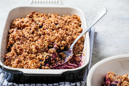 Homemade berry oat crumble pie in backing dish. Comfort food concept.