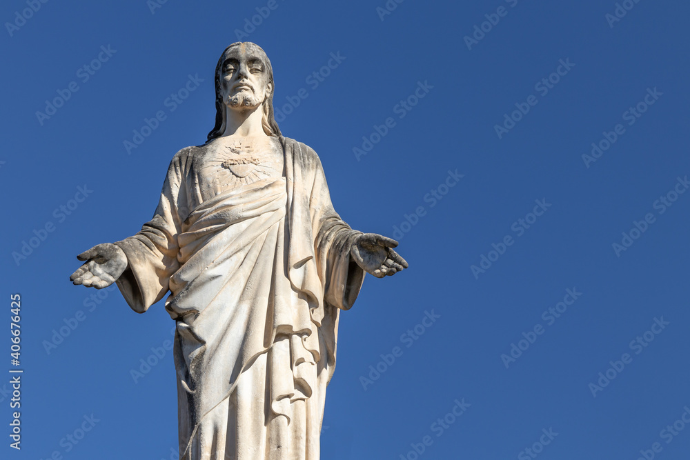 Cristo (Jesus Christ) antique statue in Sant Quirze del Valles, Spain. Clear blue sky background, copy space