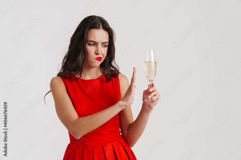 Displeased girl showing stop gesture while posing with champagne Displeased girl showing stop gesture while posing with champagne