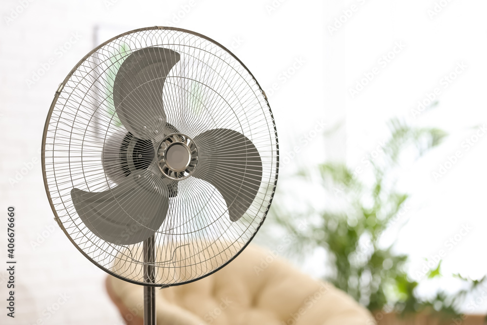 Modern electric fan in room. Space for text