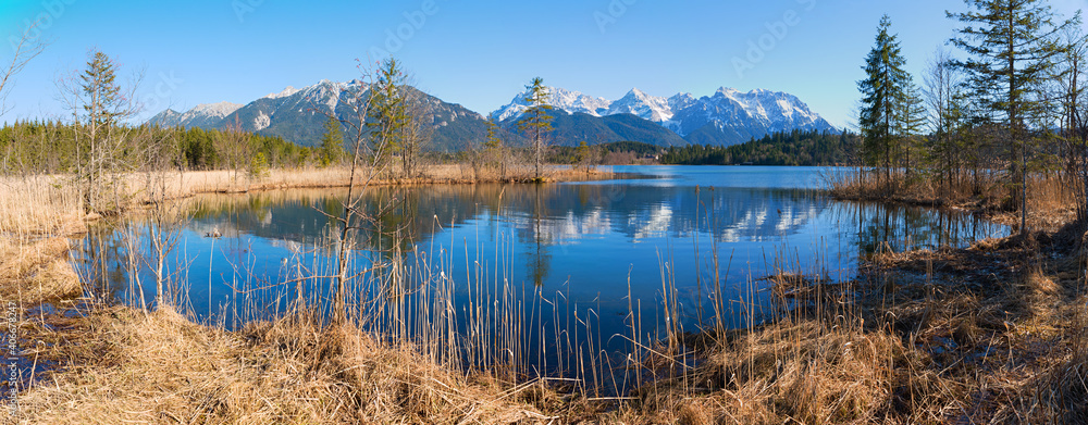 idyllic moor lake Barmsee, with blue water, view to Karwendel alps, upper bavaria