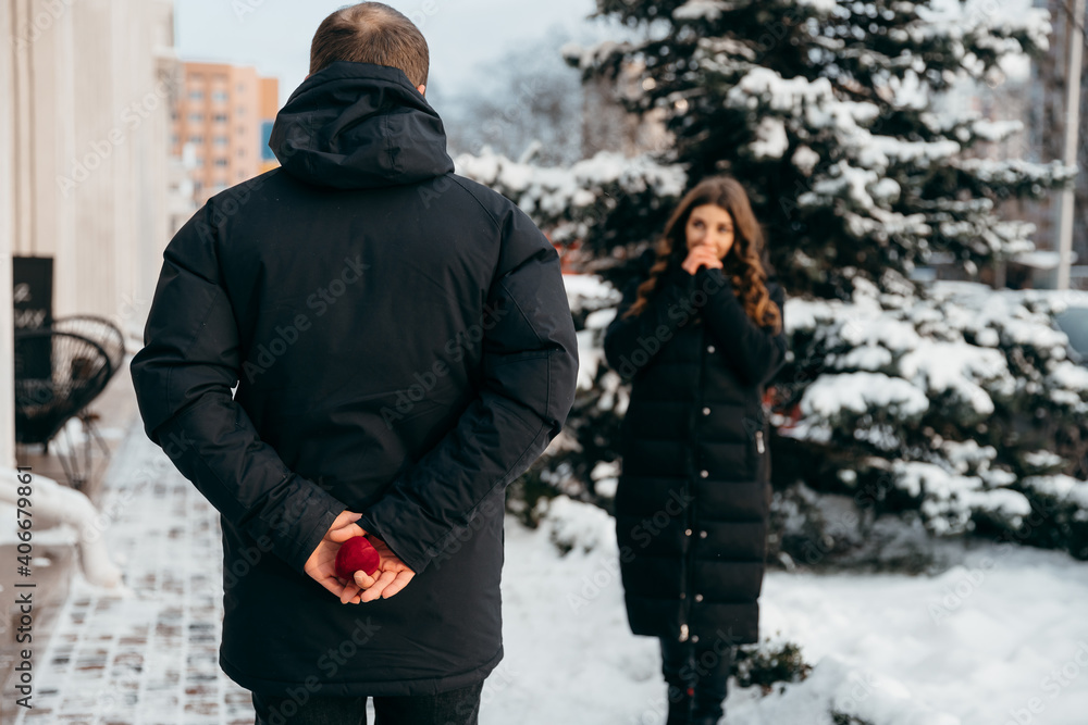 A moment of waiting before a marriage proposal. The guy holds the sleeping box with a ring A moment of waiting before a marriage proposal. The guy holds the sleeping box with a ring