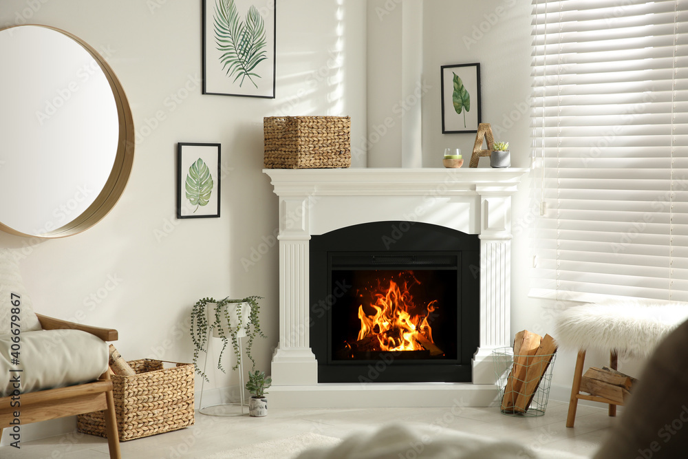 Bright living room interior with artificial fireplace and firewood in  basket Stock Photo | Adobe Stock