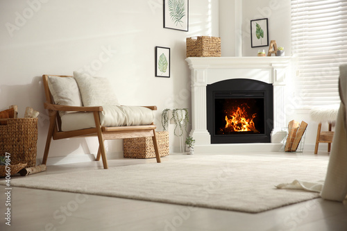 Obraz na plátne Bright living room interior with fireplace and armchair