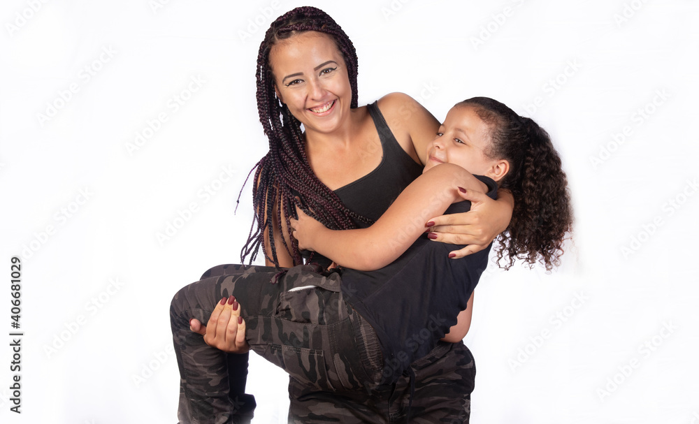 Mother and daughter dressed alike in a very happy rehearsal, white background, selective focus. Mother and daughter dressed alike in a very happy rehearsal, white background, selective focus.