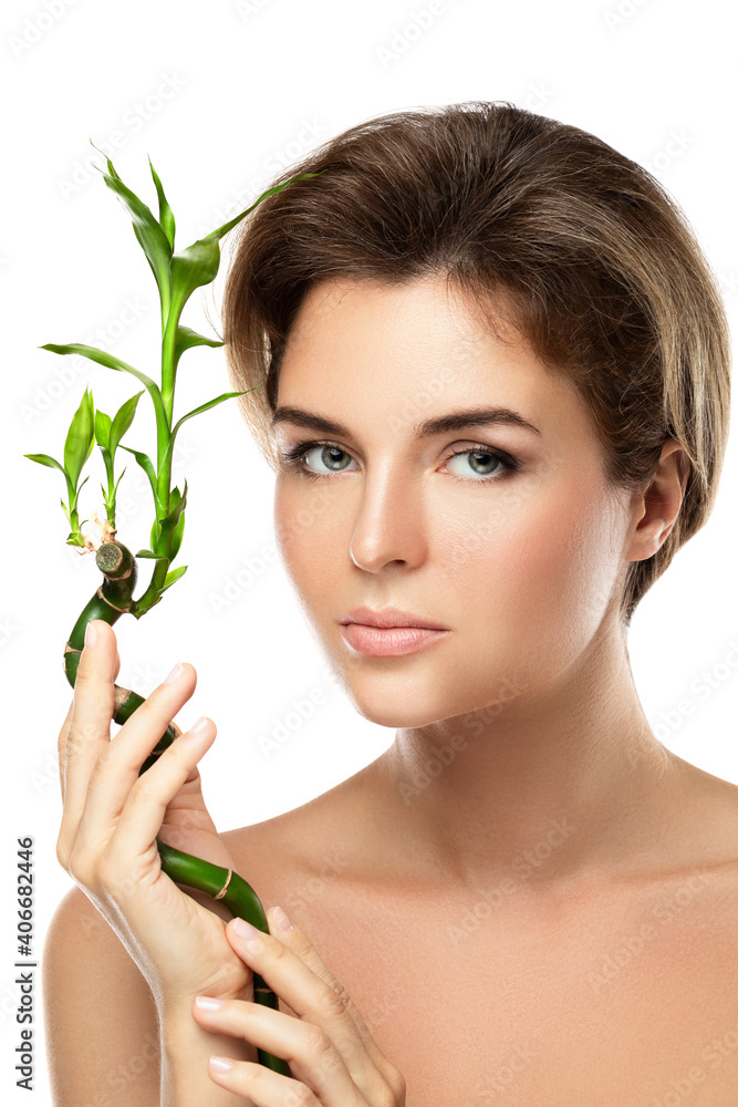 Young beautiful woman with a green bamboo branch Young beautiful woman with a green bamboo branch