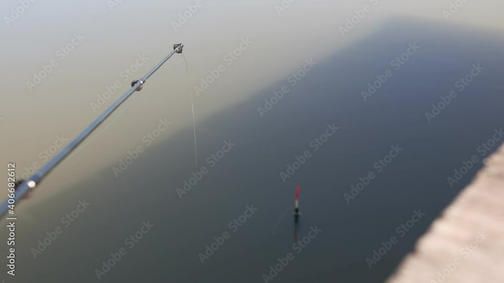 Fishing float on the water. Fishing with a float rod on the water. Fishing float on the water. Fishing with a float rod on the water.