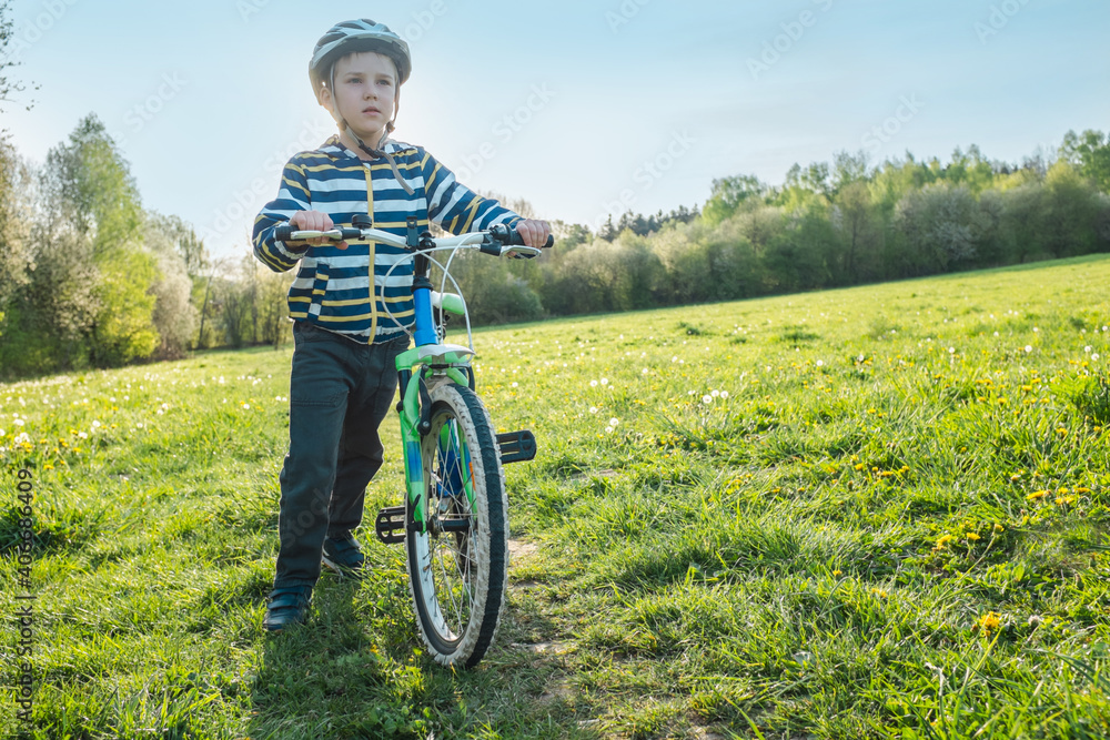 Child on bike in park. Boy going wearing safe bicycle helmets. Little Kid biking on sunny summer day. Active healthy outdoor sport Fun activity.
Child on bike in park. Boy going wearing safe bicycle helmets. Little Kid biking on sunny summer day. Active healthy outdoor sport Fun activity.