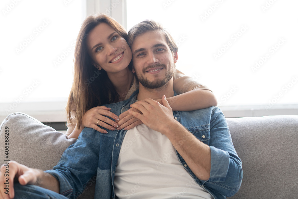 Happy couple or marriage hugging and enjoying in a couch at home. Happy couple or marriage hugging and enjoying in a couch at home.