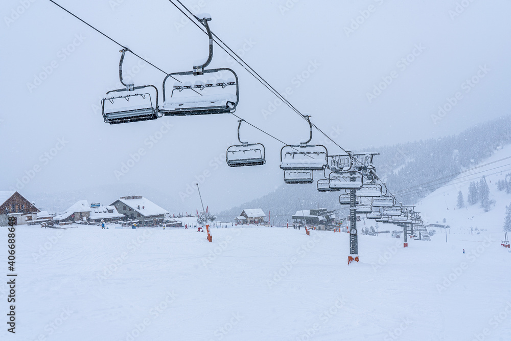 Auron, FRANCE - 01.01.2021: Empty ski slopes and ski lifts in ski resort. During the winter holidays 2021 January lifts are closed for skiing for adults due to the coronavirus pandemic. Auron, FRANCE - 01.01.2021: Empty ski slopes and ski lifts in ski resort. During the winter holidays 2021 January lifts are closed for skiing for adults due to the coronavirus pandemic.