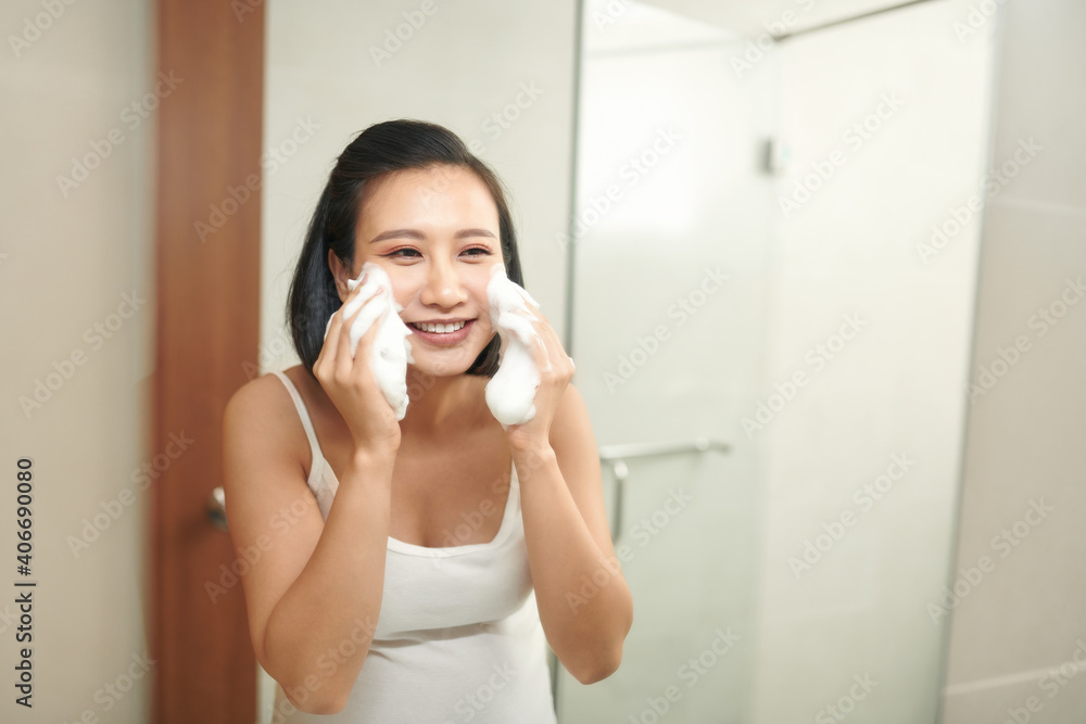 Young pregnant woman washing her face in bathroom. Young pregnant woman washing her face in bathroom.