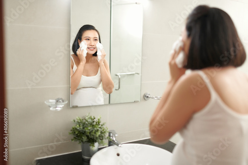 f beautiful pregnant woman washing her face in bathroom