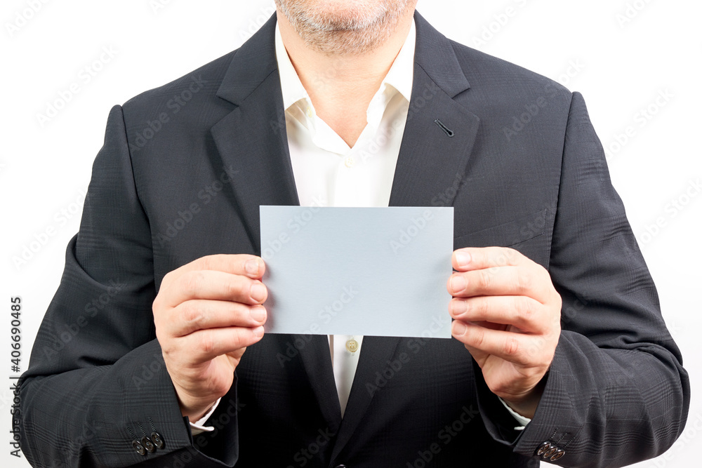 Businessman in black suit holding a blue card with copy space