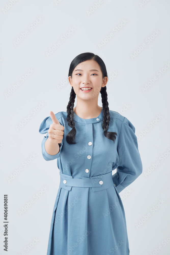 Young Asian woman showing thumb isolated on white background. Young Asian woman showing thumb isolated on white background.