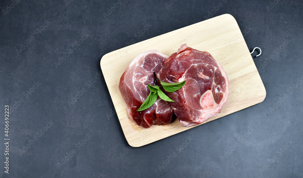Fresh pork on a cutting board, perfect for presentations