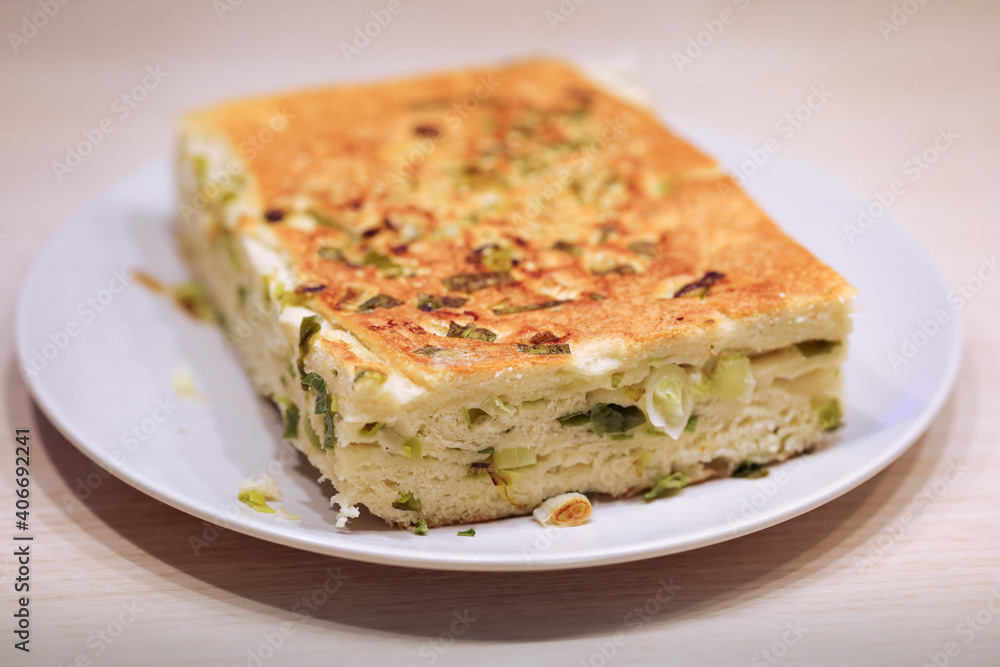 Close up of vegan halal food known as sesame scallion bread or pancake, a popular staple in Northern Asia. The bread is stuffed with spring onions and topped with sesame.