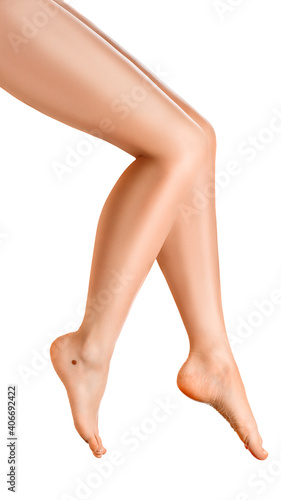 Beautiful well-groomed women's legs close-up on a white isolated background vertical photo, The concept of epilation of foot skin care or getting rid of cellulite.