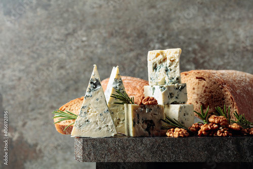 Blue cheese with walnuts, bread, and rosemary.